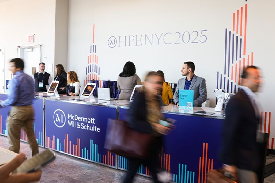 Photo of attendees and staff at the registration desk during HPE NYC 2025 (credit: McDermott Will & Schulte)