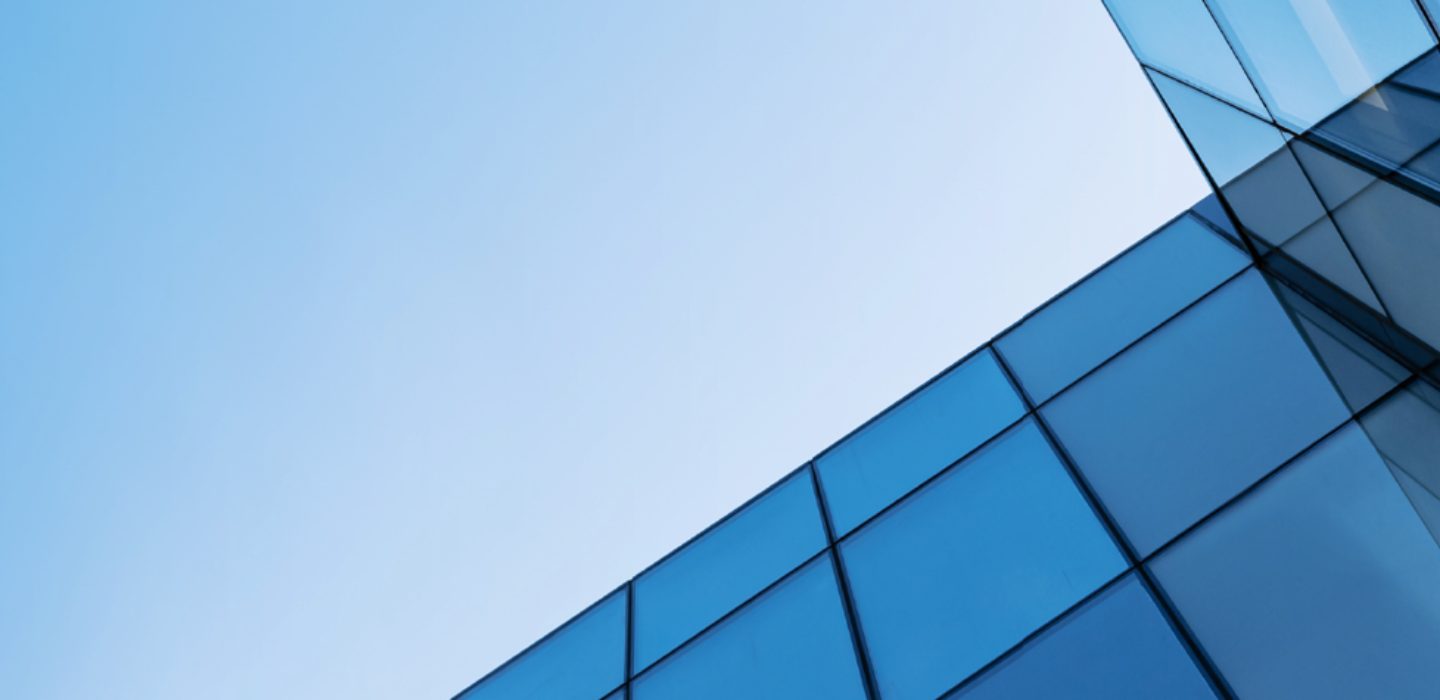 Low-angle view of the sky framed by a modern glass building (credit: Getty Images)