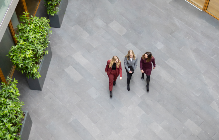 Staff professionals walk and talk en route to a meeting at one of the firm’s Germany offices. (credit: McDermott Will & Schulte)