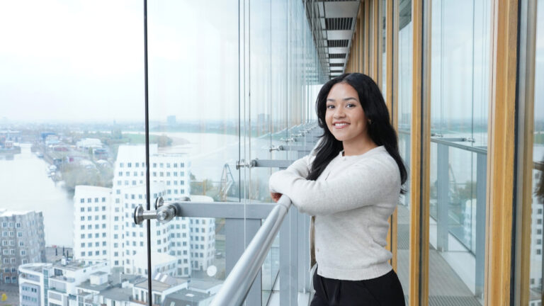 A staff professional poses as they take in the views from one of the firm’s Germany offices. (credit: McDermott Will & Schulte)