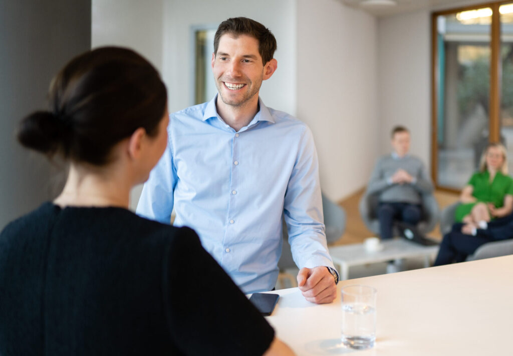 Employees mingle in a common space at one of the firm’s Germany offices (credit: McDermott Will & Schulte)