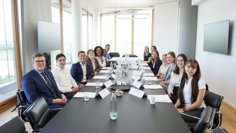 Interns post for a photo around a conference table in a meeting room at one of the firm’s Germany offices. (credit: McDermott Will & Schulte)