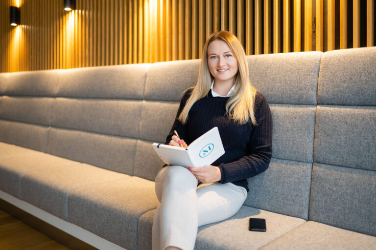 An employee smiles for the camera in the lobby of one of the firm’s Germany offices. (credit: McDermott Will & Schulte)