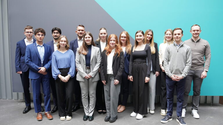 Interns pose for a photo against a wall at one of the firm’s Germany offices. (credit: McDermott Will & Schulte)