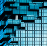 Close-up facade of a modern, glass building (source: Getty Images)