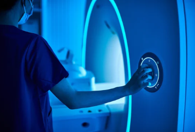 Close-up of a female nurse operating an MRI scan machine in an MRI-scanner room. (source: Getty Images)